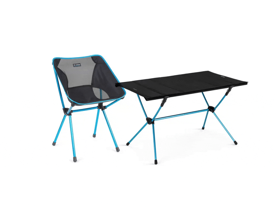 A single camping chair next to camping table.